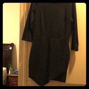 A black curve-hugging dress